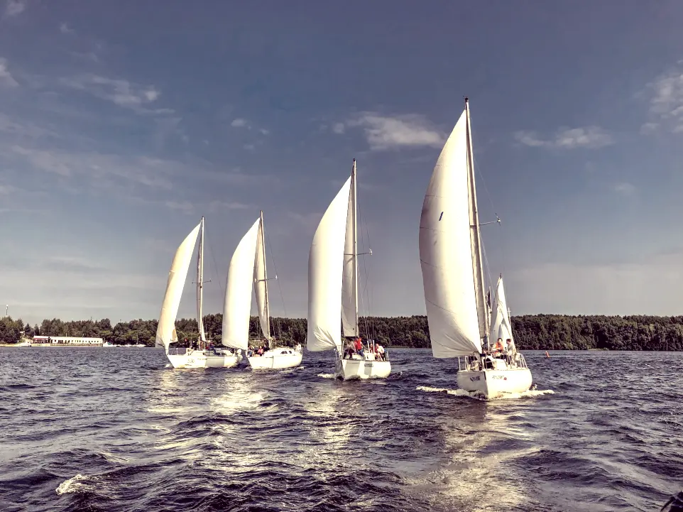 white sail boat on sea under blue sky during daytime